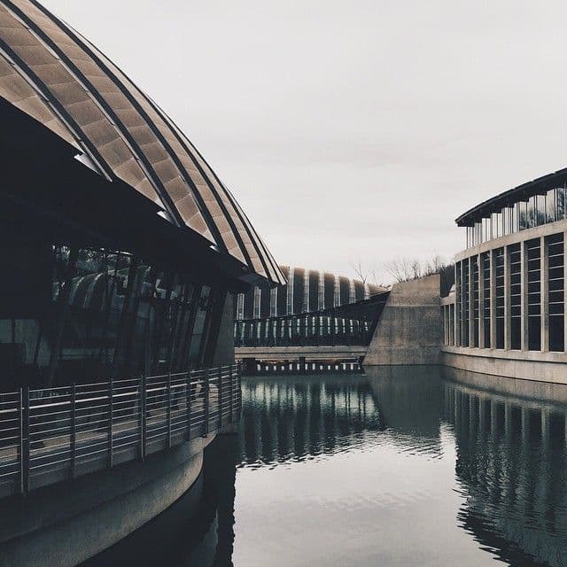 Buildings connected together, floating on water.